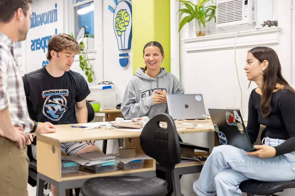 A group of students discuss a prototype that will encourage more people to get outdoors in Maine.